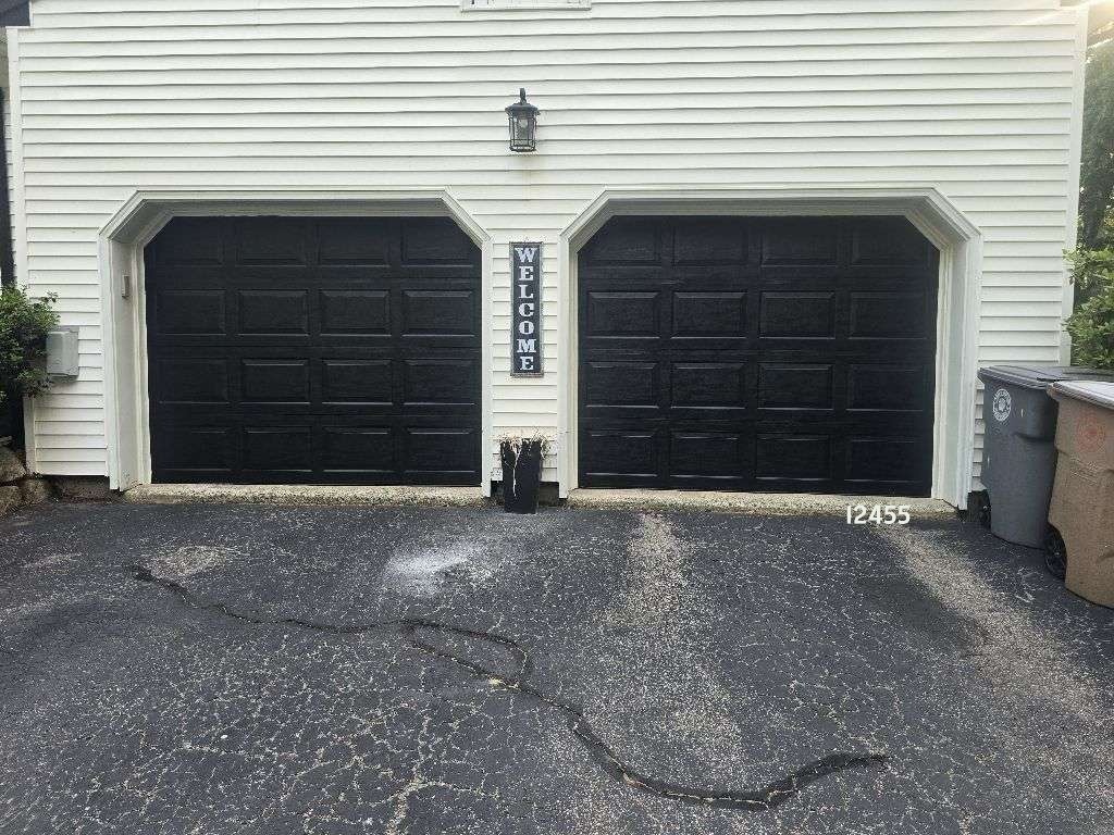 General Doors Advantage black garage door installation in Niantic, CT by Ace Overhead Doors featuring an insulated steel garage door that enhances curb appeal, durability, and energy efficiency.